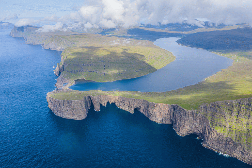 The lake Leitisvatn Sørvágsvatn Vatnið on Vágar island is the biggest lake in the Faroe Islands. The area Trælanípan also called Lake Above the Ocean. Nípan is at the end of the lake, where you will find the waterfall  Bøsdalafossur.